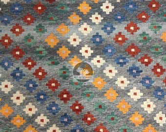 May include: A gray rug with a geometric pattern of colorful diamonds. The diamonds are in shades of red, blue, yellow, green, and white.