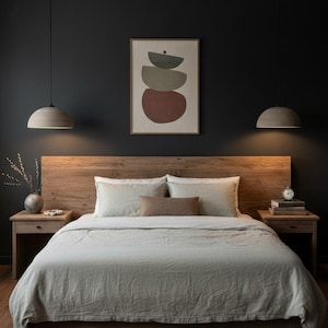 May include: A bedroom featuring a wooden bed with a headboard and bedside tables. The bed is dressed with light-coloured bedding and pillows. Two pendant lights are suspended above. An abstract artwork hangs on the dark wall.