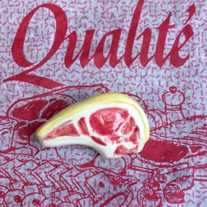 Enamelled earthenware chop brooch