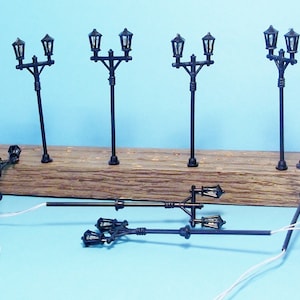 New HO Scale LED 2 Lamp Cast Iron Looking Lights. Set includes 8 Lights, resistors and a Diagram for 16V use.