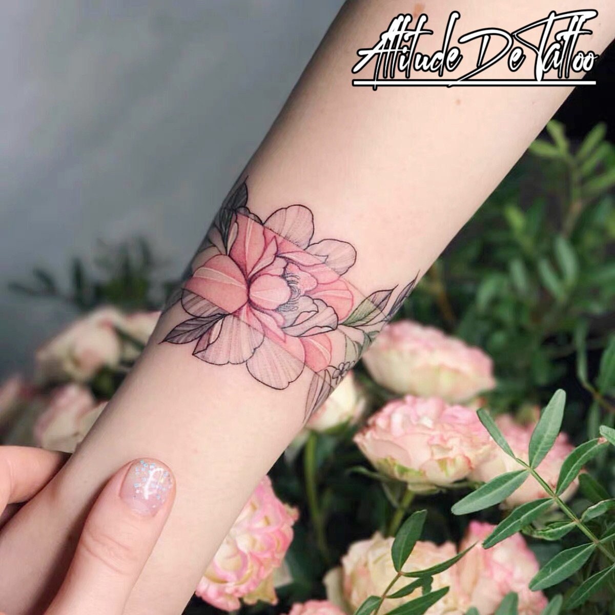 Fine line rose tattoo on the wrist.