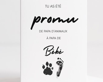 May include: A white greeting card with black text and paw and footprint illustrations. The card reads "You were promised, from pet dad to dad of baby."