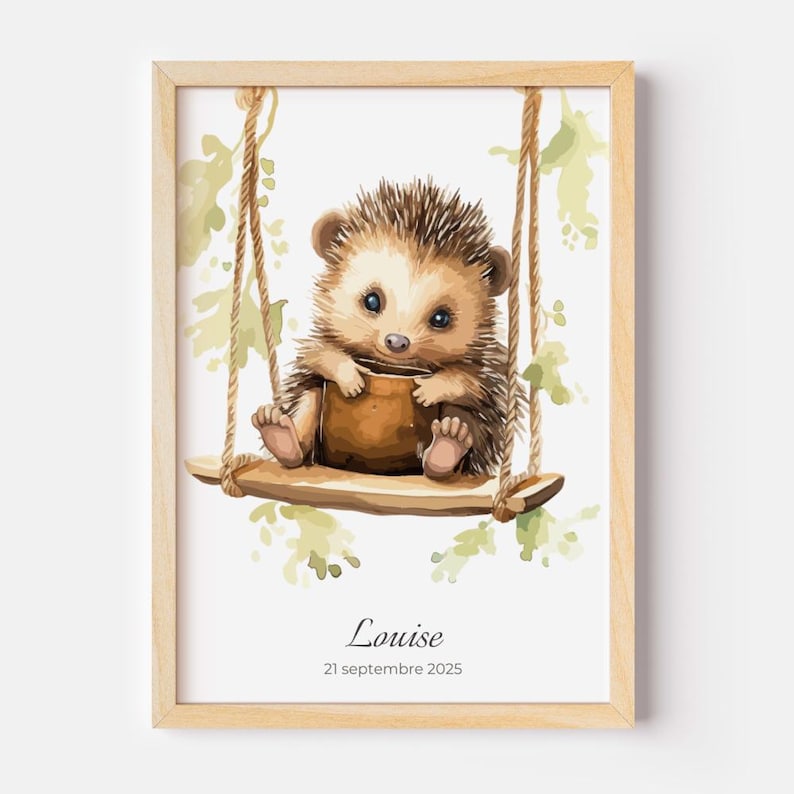 May include: A framed watercolor print features a cute hedgehog on a wooden swing. The hedgehog is brown and tan with blue eyes, holding a brown object. The print includes the name "Louise" and the date "21 septembre 2025".