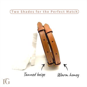 May include: Two leather straps in shades of tan and warm honey, with yellow stitching and metal hardware. The text reads "Two Shades for the Perfect Match", "Tanned beige", and "Warm honey".
