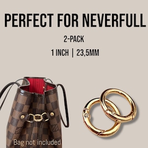 May include: Two gold-coloured, circular bag clasps, each 2.5 cm in diameter, are displayed next to a brown and tan checkered handbag. The text "PERFECT FOR NEVERFULL" and "2-PACK" are visible at the top of the image.