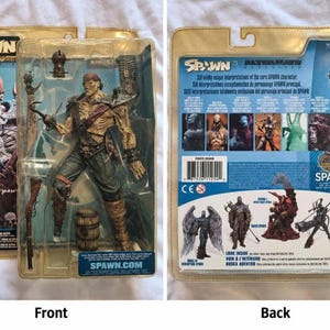 May include: A Pirate Spawn action figure in its original plastic blister packaging. The figure features a weathered pirate aesthetic with a hook hand, a musket, and a small barrel. The packaging includes the Spawn logo and text, with a detailed character illustration on the front and a collection display on the back.