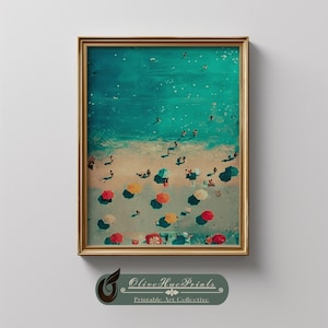 May include: A framed print of a beach scene with people, colorful umbrellas, and turquoise water. The artwork has a vintage aesthetic, with a gold frame and the text "Olive Hue Prints" at the bottom.