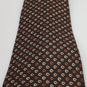 Luxury vintage Brummell tie. Brown with beige, cream, and orange patterns. Made in Italy for Brummell, 100% acetate Paris.