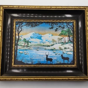 Painting depicting a deer and a doe in a snowy landscape