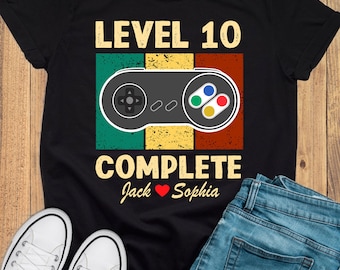 May include: Black t-shirt with a retro video game controller graphic and the text "Level 10 Complete Jack ♥ Sophia".