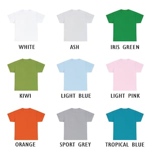 May include: A collection of nine solid-color t-shirts in various hues, including white, ash, iris green, kiwi, light blue, light pink, orange, sport grey, and tropical blue. Each shirt is displayed with its color name in a bold, sans-serif font.