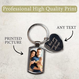 May include: A silver metal keychain with a rectangular photo frame and a heart-shaped charm. The photo frame contains a family portrait. The heart charm is engraved with the words "I love you now and always". The text "Professional High Quality Print" is at the top.