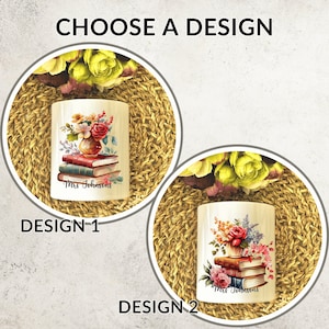May include: Two cylindrical designs are presented, each featuring a floral arrangement atop a stack of books. Design 1 has a vase with red roses and the text "Mrs. Johnsons". Design 2 has a similar design with pink flowers.