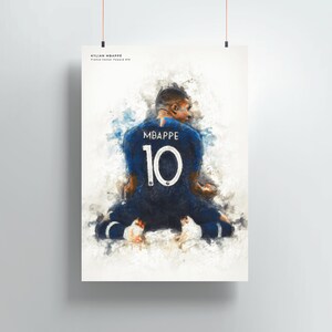 May include: A watercolor painting of a soccer player wearing a blue jersey with the number 10 and the name "MBAPPE" on the back. The player is kneeling on the field with their back to the viewer.