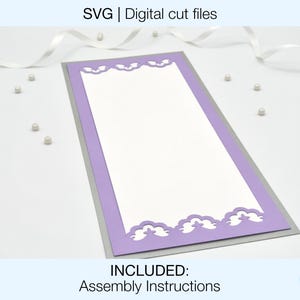 May include: A purple and silver card with a decorative cut-out design. The card is blank and ready for personalisation.  INCLUDED: Assembly Instructions