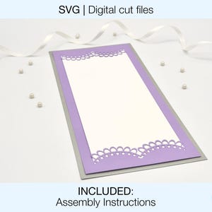 May include: A purple and silver card with a decorative border. The card is blank inside and has the text "INCLUDED: Assembly Instructions" at the bottom.