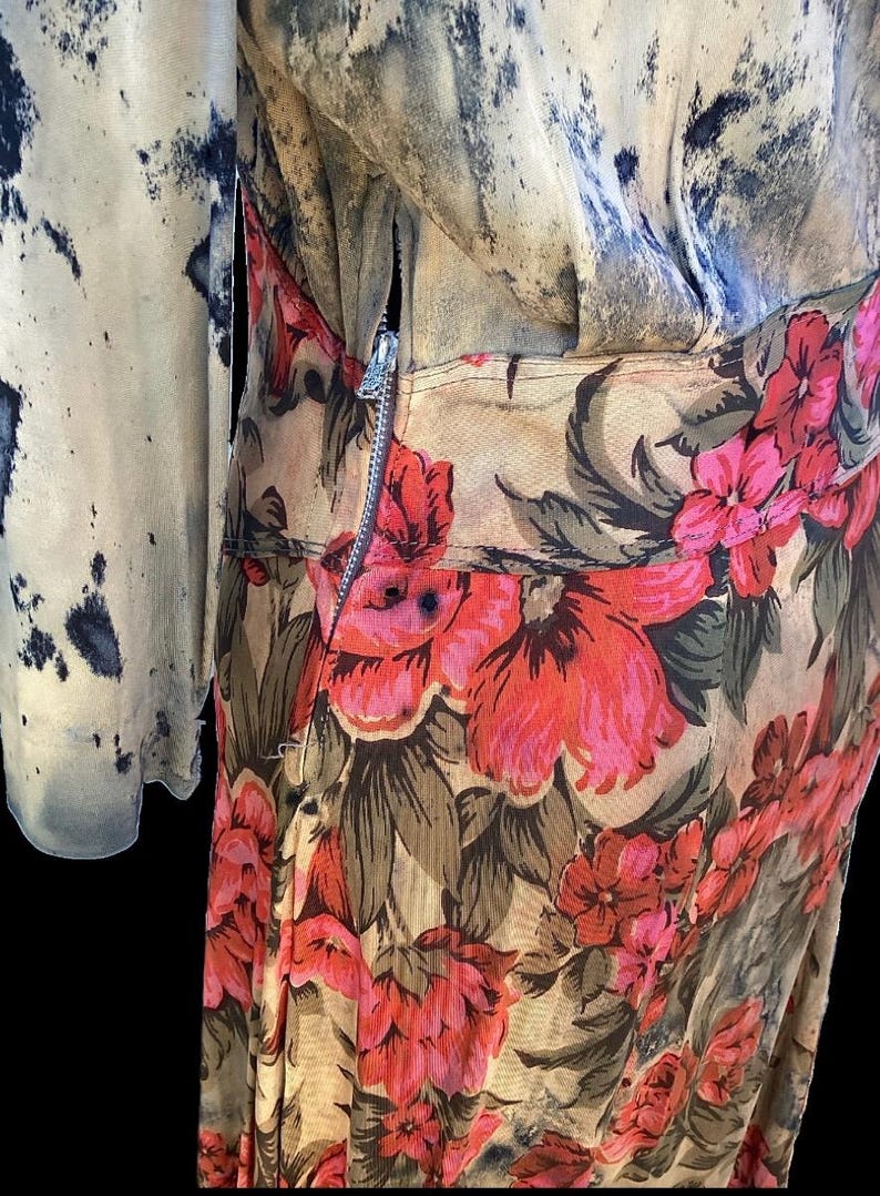 May include: A vintage floral dress with a zipper closure. The dress features a beige background with large red and pink flowers and green leaves. The sleeve on the left has a blue and beige pattern.