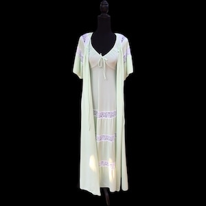 May include: A light green, long, lace-trimmed nightgown with a matching robe. The nightgown has a V-neckline and a tie at the waist. The robe has long sleeves and a tie at the waist.
