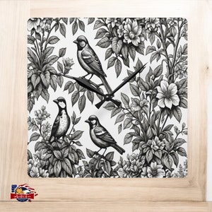 May include: Black and white clock with a floral design and three birds. The clock face is white with black hands.