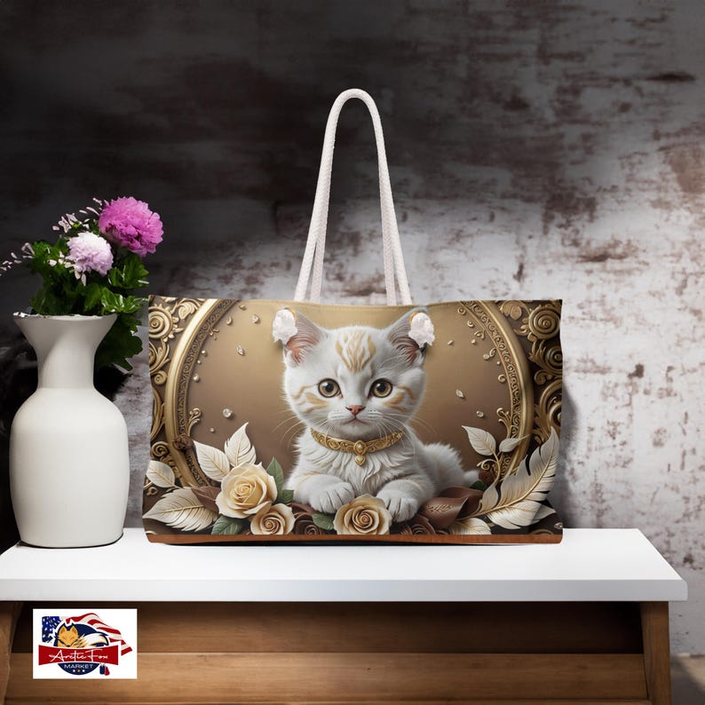 Oversized Weekender Tote Bag with adorable kitten design set against a gold and cream floral background, perfect for stylish adventurers.
Spun Polyester Travel Tote featuring unique vine swirls and cream roses. Arcticfoxmarket.com