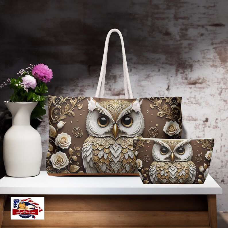 May include: A brown tote bag and a matching bowl with a 3D owl design. The owl is white with gold accents and has intricate details. The bag has a white handle and a brown background with gold floral accents.