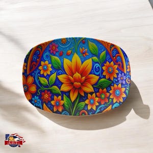 May include: An oval serving platter with a vibrant blue background and a colorful floral design. The design features a large orange flower with yellow petals and green leaves, surrounded by smaller flowers in shades of red, yellow, orange, and purple.