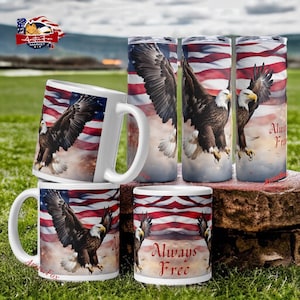 May include: Set of five mugs and tumblers featuring a bald eagle flying in front of an American flag. The mugs and tumblers are white with a red, white, and blue design. One of the mugs has the text "Always Free" printed on it.