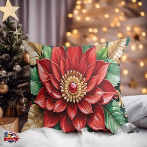 May include: A red poinsettia flower with gold accents and a ruby red jewel in the center. The flower is surrounded by green leaves and gold accents. The pillow is perfect for adding a touch of holiday cheer to your home.