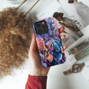 May include: A phone case with a colorful coral reef design. The case is made of a durable material and features a raised camera bump for added protection.