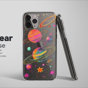 May include: Clear phone case with a colorful space-themed design. The case features planets with rings, stars, and a matte finish. The text "Clear Case" is displayed on the left side of the image.