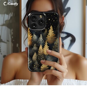 May include: Black phone case with a gold glitter and forest design. The case features a pattern of gold leaves and trees on a black background with gold glitter accents.