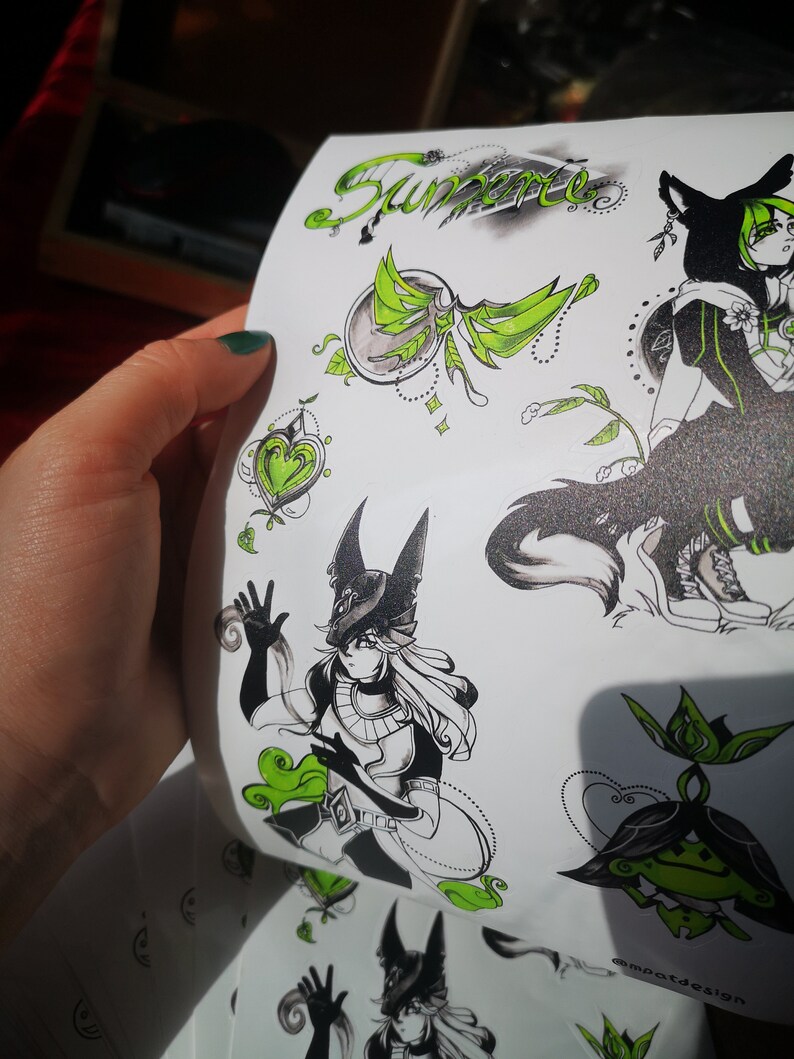 May include: A set of black and green stickers featuring a stylized illustration of a character with wolf ears and a green glowing aura. The stickers also include a heart, a flower, and the word "Summer" in cursive.