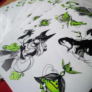 May include: A set of black and green stickers featuring a variety of designs, including a character with a hat and a green frog. The stickers are printed on white paper and have a glossy finish.