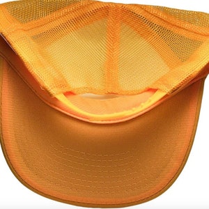 May include: A yellow mesh trucker hat with a solid yellow brim. The hat is made of a breathable mesh material and has a classic trucker hat style.