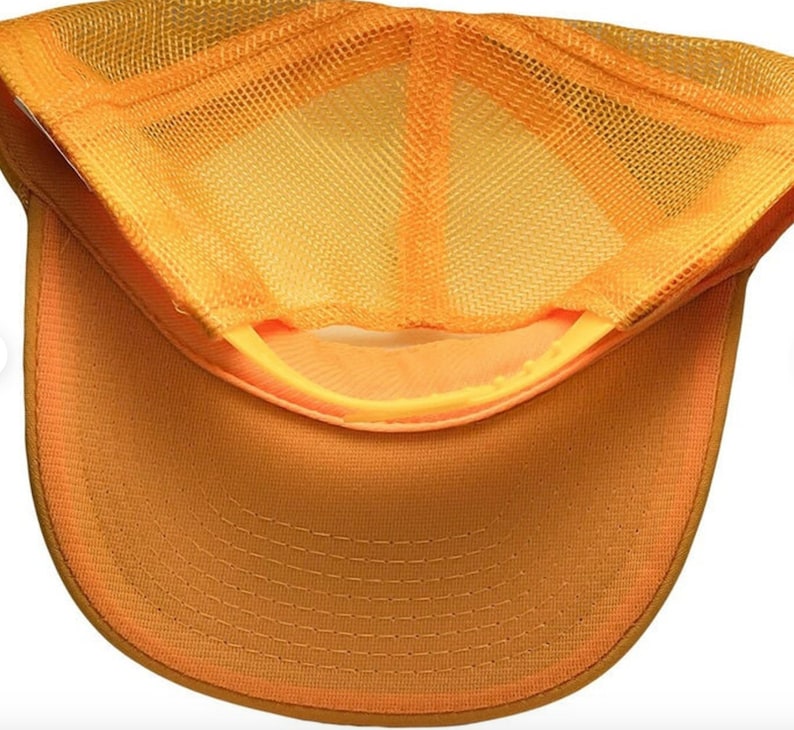 May include: A yellow mesh trucker hat with a solid yellow brim. The hat is made of a breathable mesh material and has a classic trucker hat style.