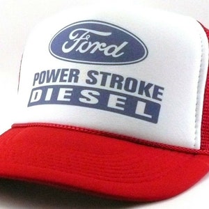 May include: Red and white trucker hat with a blue Ford logo and the text "Power Stroke Diesel".