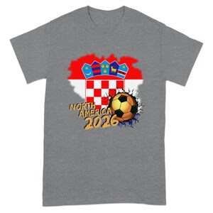 Gray t-shirt with cracked earth graphic and soccer ball, featuring Croatia flag and "NORTH AMERICA 2026".