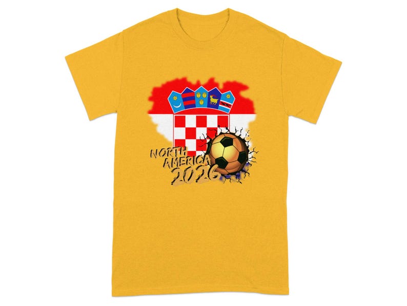 Yellow t-shirt with a cracked soccer ball and "North America 2026" text.