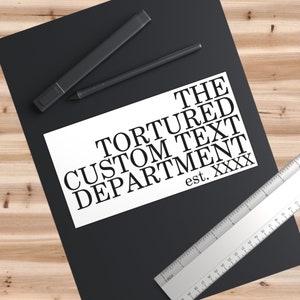May include: A white card with black text that reads "The Tortured Custom Text Department est. XXXX".