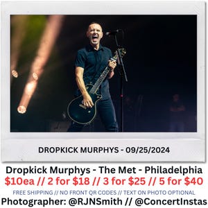 May include: A live performance photo of a musician playing a black electric guitar and singing into a microphone. The stage is lit with spotlights. Text on the image reads "DROPKICK MURPHYS - 09/25/2024" and "Dropkick Murphys - The Met - Philadelphia".