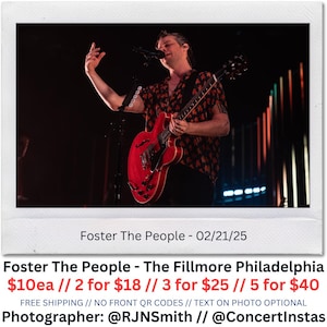 Puede incluir: Foto de concierto en vivo de Foster The People actuando en el escenario. El cantante principal toca una guitarra eléctrica roja y canta en un micrófono. La foto está enmarcada en un borde blanco con el texto "Foster The People - 02/21/25" y "Foster The People - The Fillmore Philadelphia".