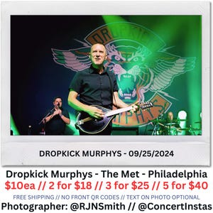May include: A live concert photo of Dropkick Murphys performing on stage. The band's logo, featuring a tiger and wings, is visible in the background. The image includes the date, venue, and photographer's social media handles.