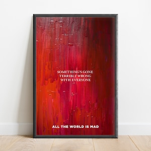 May include: A framed art print with a red abstract background and white text that reads "Something's gone terribly wrong with everyone. All the world is mad."