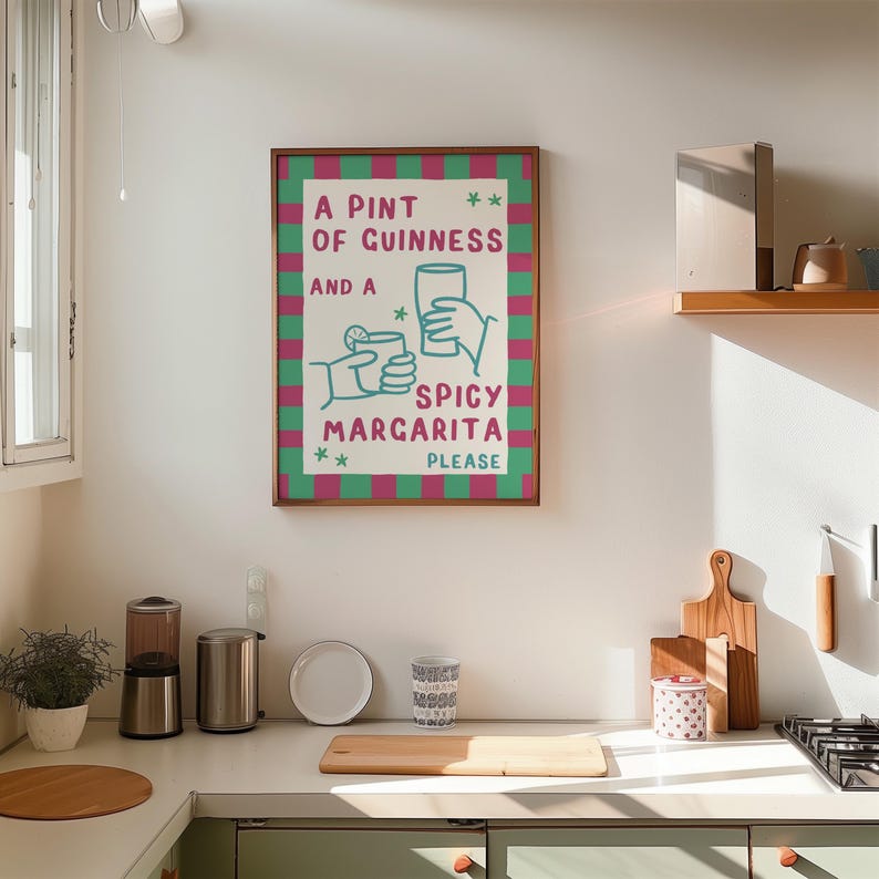 May include: A framed print with the text "A Pint of Guinness and a Spicy Margarita Please" in a whimsical font. The print has a green and pink checkered border and illustrations of a pint and a margarita.