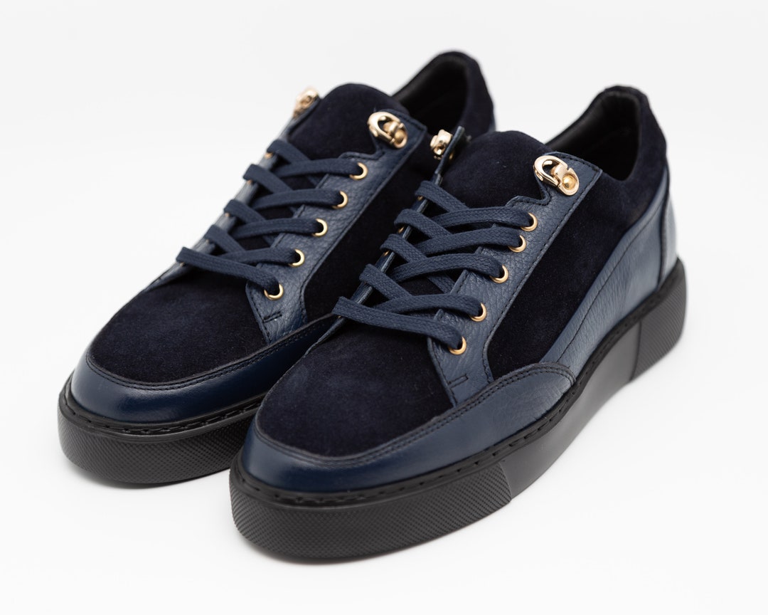 navy blue and gold sneakers