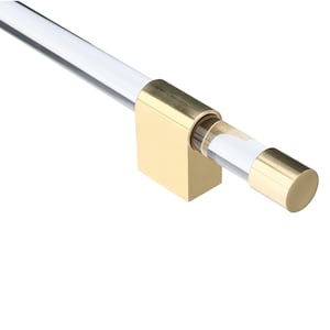 May include: A clear acrylic rod handle featuring a polished gold-tone metal mounting bracket and a matching cylindrical gold-tone end cap. The hardware is designed with a sleek, transparent bar that connects to the metallic base and terminal piece.