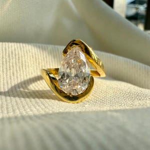 3.49 CT Pear Moissanite Engagement Ring: 10K Yellow Gold Hidden Halo