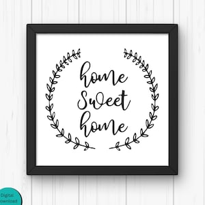 May include: Black and white printable wall art with a wreath of leaves and the text "home sweet home".