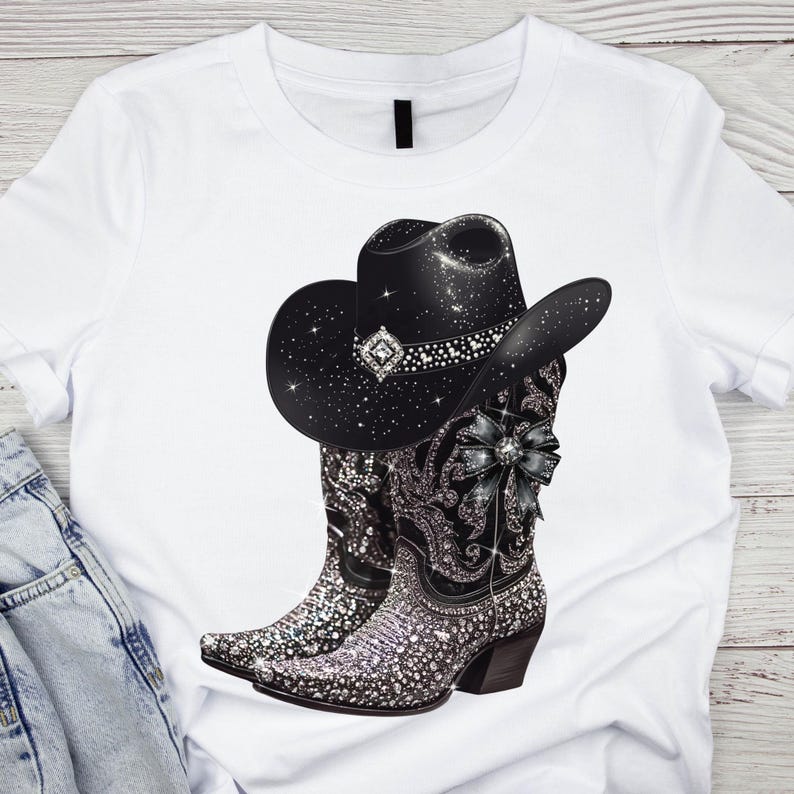 May include: White t-shirt with a black cowboy hat and sparkly silver boots. The hat has rhinestones and a black bow. The boots have a black bow and rhinestones.