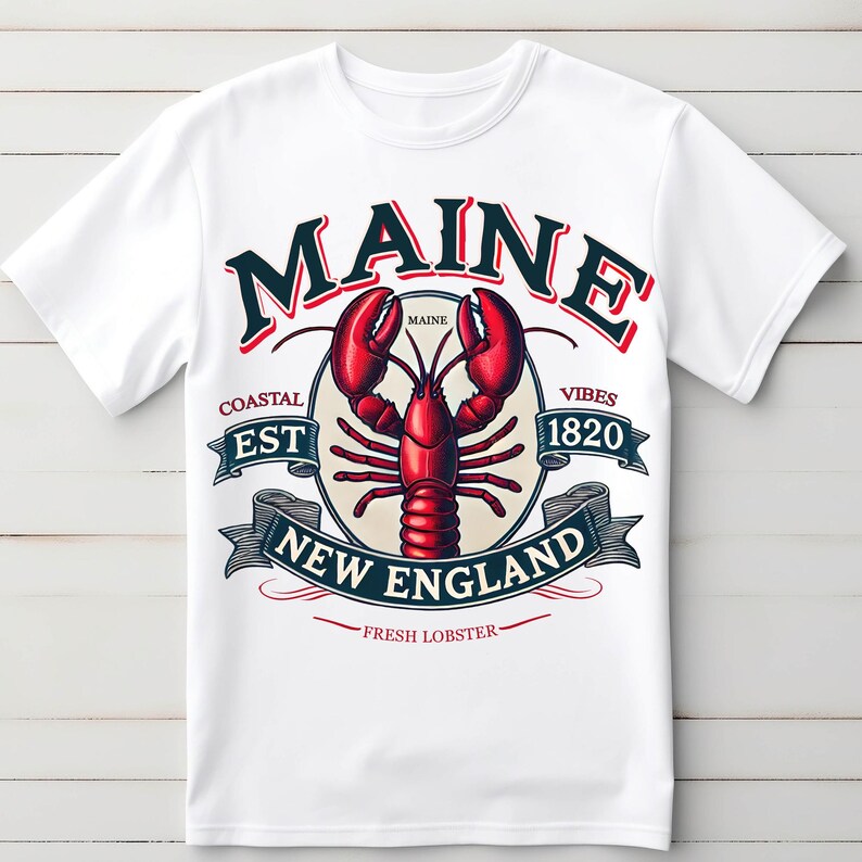 May include: White t-shirt with a graphic design featuring a lobster and the text "Maine Coastal Est 1820 Vibes New England Fresh Lobster".